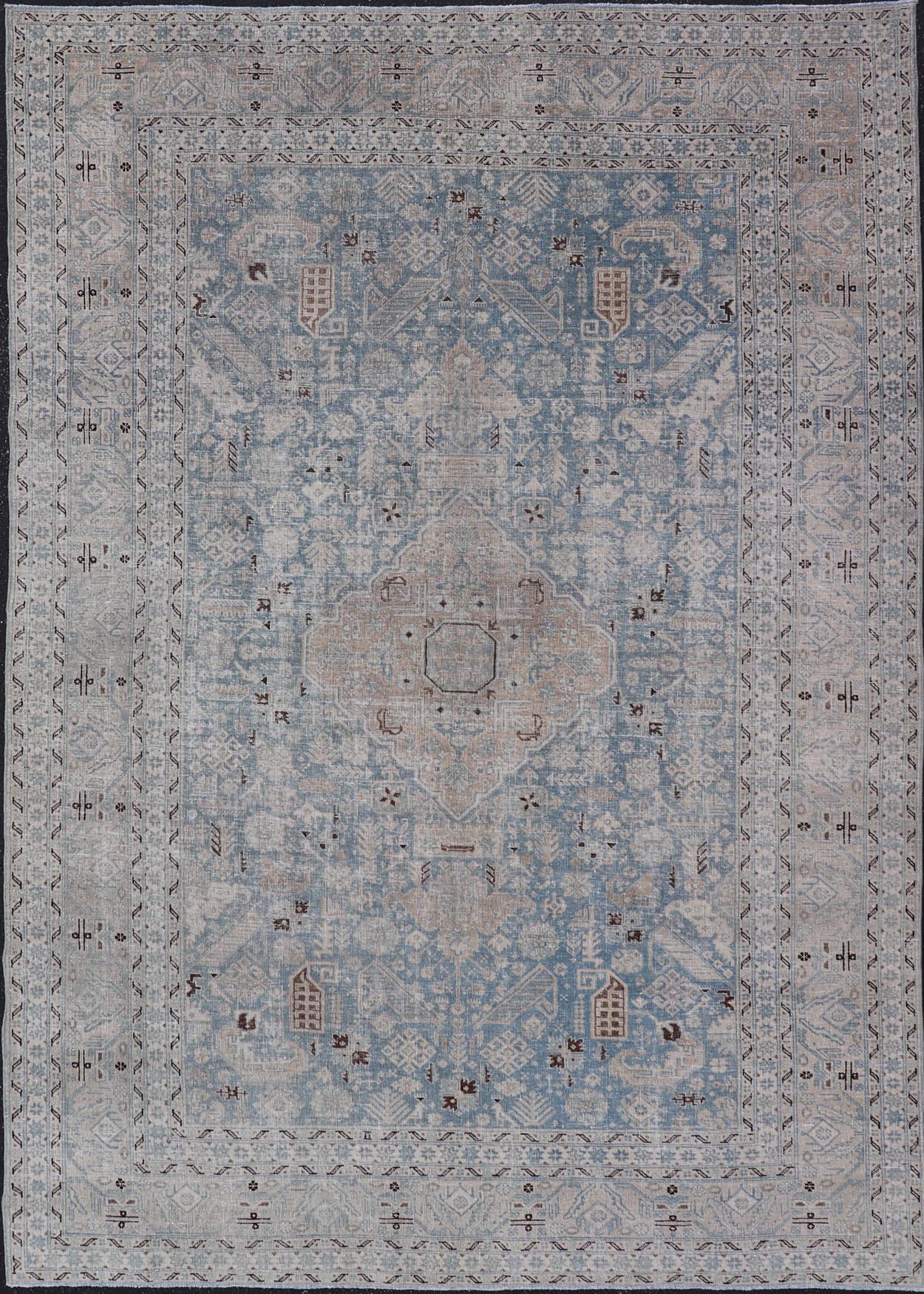 Measures: 6'0 x 9'0 The rug's central field is highlighted by a soft blue background adorned with a detailed medallion pattern in shades of beige and ivory. The design includes various geometric and floral motifs that are arranged symmetrically, cr... - Keivan Woven ArtsEMB - 22236 - 22460
