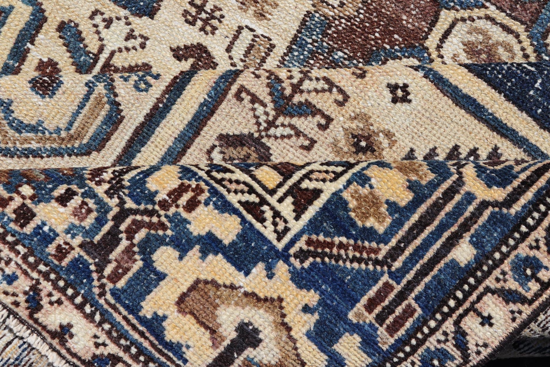 Measures: 4'4 x 6'9 The rug's central field showcases a prominent medallion pattern set against a deep blue background, accented with beige and brown geometric and floral motifs. The medallion itself is highly detailed, featuring a complex arrangem... - Keivan Woven ArtsEMB - 22237 - 22466