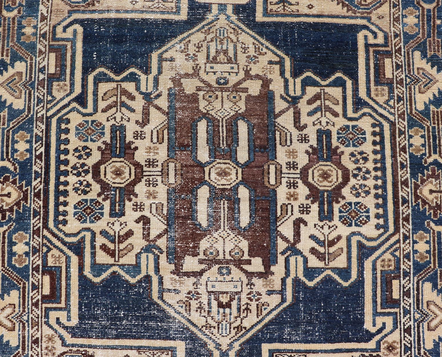 Measures: 4'4 x 6'9 The rug's central field showcases a prominent medallion pattern set against a deep blue background, accented with beige and brown geometric and floral motifs. The medallion itself is highly detailed, featuring a complex arrangem... - Keivan Woven ArtsEMB - 22237 - 22466