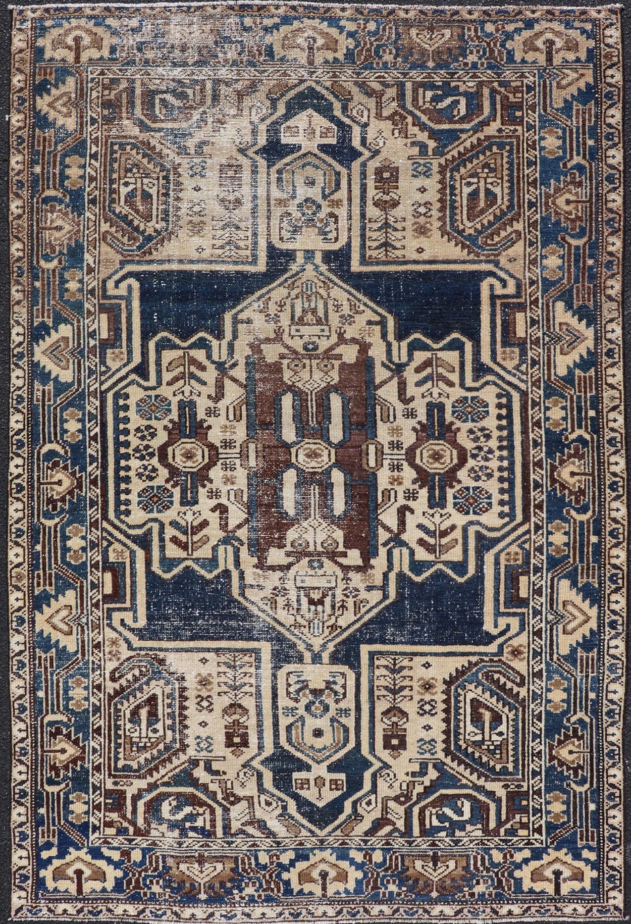 Measures: 4'4 x 6'9 The rug's central field showcases a prominent medallion pattern set against a deep blue background, accented with beige and brown geometric and floral motifs. The medallion itself is highly detailed, featuring a complex arrangem... - Keivan Woven ArtsEMB - 22237 - 22466