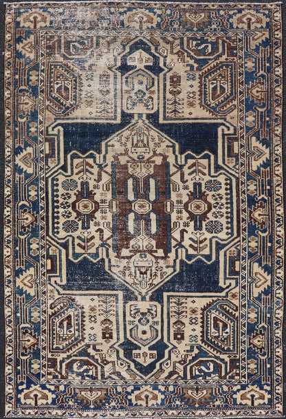 Measures: 4'4 x 6'9 The rug's central field showcases a prominent medallion pattern set against a deep blue background, accented with beige and brown geometric and floral motifs. The medallion itself is highly detailed, featuring a complex arrangem... - Keivan Woven ArtsEMB - 22237 - 22466