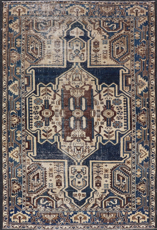Measures: 4'4 x 6'9 The rug's central field showcases a prominent medallion pattern set against a deep blue background, accented with beige and brown geometric and floral motifs. The medallion itself is highly detailed, featuring a complex arrangem... - Keivan Woven ArtsEMB - 22237 - 22466