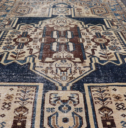 Measures: 4'4 x 6'9 The rug's central field showcases a prominent medallion pattern set against a deep blue background, accented with beige and brown geometric and floral motifs. The medallion itself is highly detailed, featuring a complex arrangem... - Keivan Woven ArtsEMB - 22237 - 22466