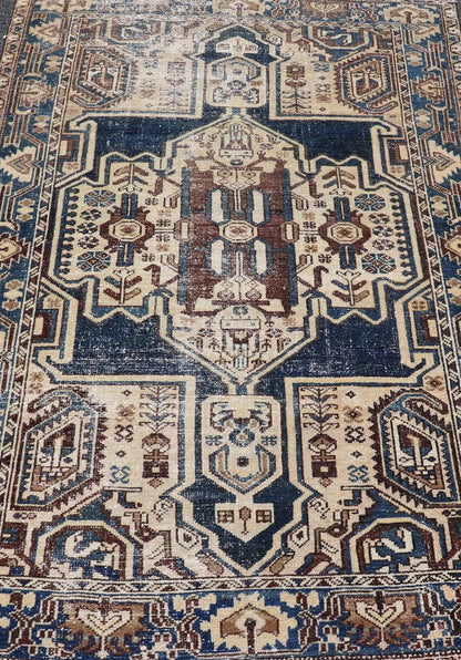 Measures: 4'4 x 6'9 The rug's central field showcases a prominent medallion pattern set against a deep blue background, accented with beige and brown geometric and floral motifs. The medallion itself is highly detailed, featuring a complex arrangem... - Keivan Woven ArtsEMB - 22237 - 22466