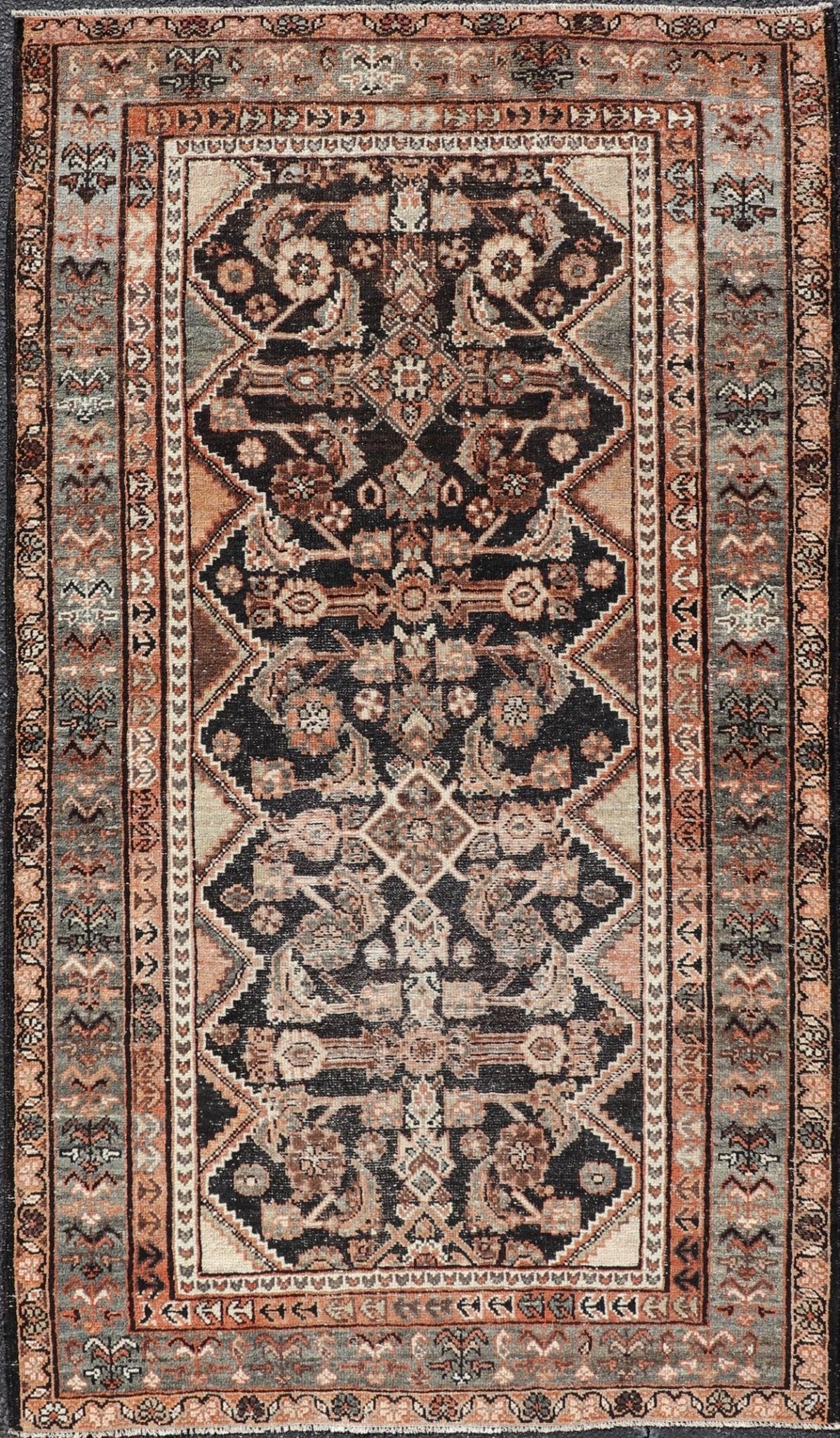 Measures: 3'6 x 6'4 The rug's central field features a dark background adorned with detailed floral and geometric motifs in shades of beige, brown, and soft orange. The design is symmetrical, with a central medallion and repeating patterns that cre... - Keivan Woven ArtsEMB - 22239 - 22478