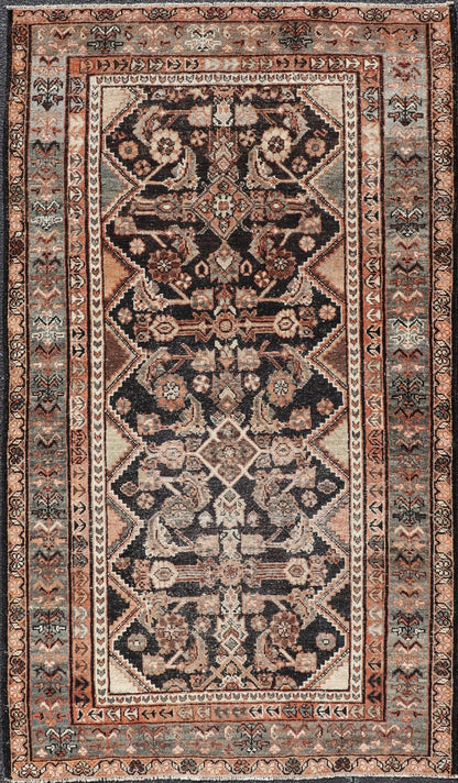 Measures: 3'6 x 6'4 The rug's central field features a dark background adorned with detailed floral and geometric motifs in shades of beige, brown, and soft orange. The design is symmetrical, with a central medallion and repeating patterns that cre... - Keivan Woven ArtsEMB - 22239 - 22478