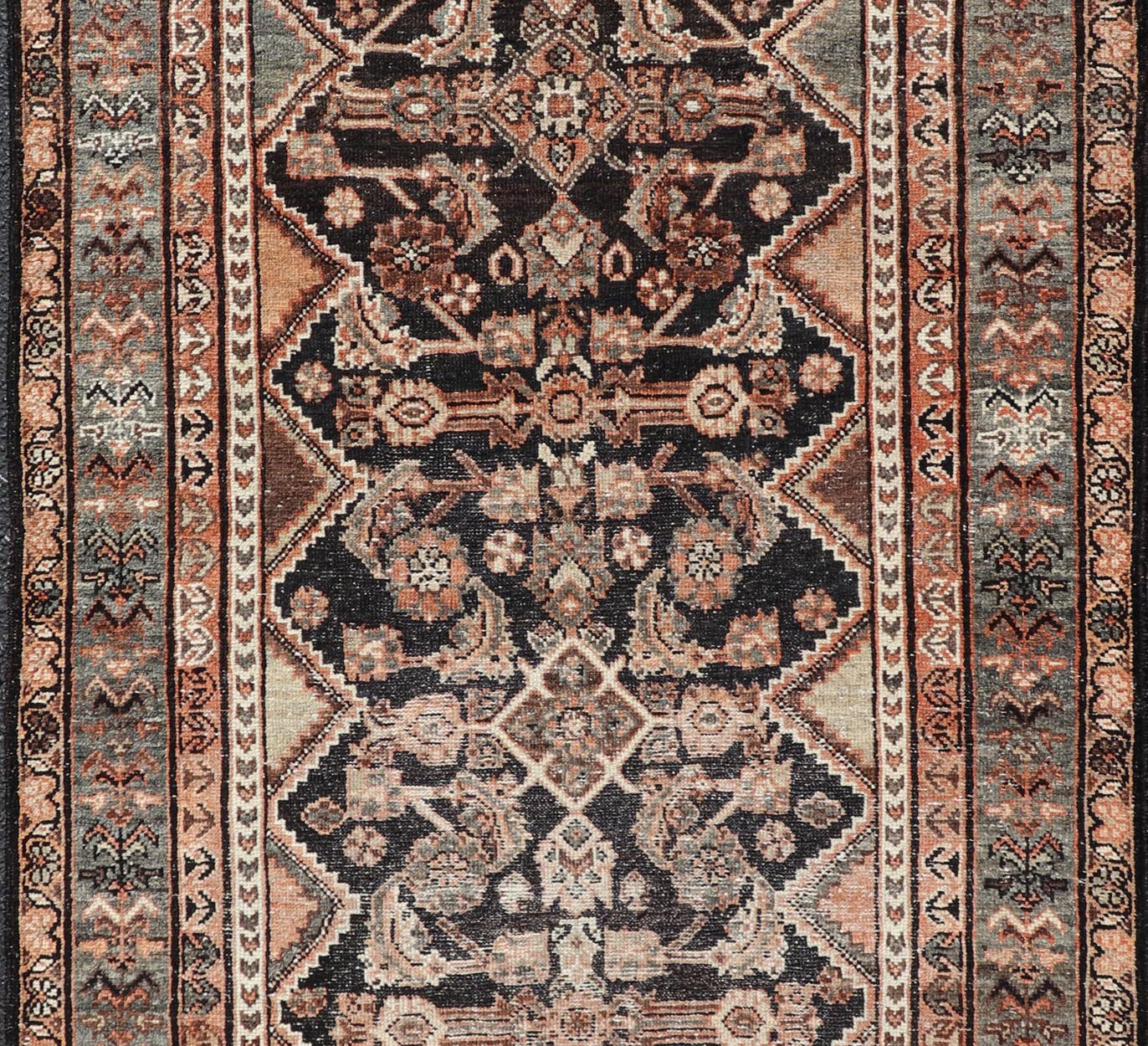 Measures: 3'6 x 6'4 The rug's central field features a dark background adorned with detailed floral and geometric motifs in shades of beige, brown, and soft orange. The design is symmetrical, with a central medallion and repeating patterns that cre... - Keivan Woven ArtsEMB - 22239 - 22478