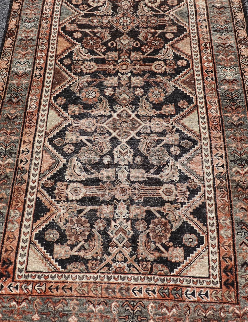 Measures: 3'6 x 6'4 The rug's central field features a dark background adorned with detailed floral and geometric motifs in shades of beige, brown, and soft orange. The design is symmetrical, with a central medallion and repeating patterns that cre... - Keivan Woven ArtsEMB - 22239 - 22478