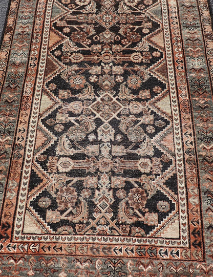 Measures: 3'6 x 6'4 The rug's central field features a dark background adorned with detailed floral and geometric motifs in shades of beige, brown, and soft orange. The design is symmetrical, with a central medallion and repeating patterns that cre... - Keivan Woven ArtsEMB - 22239 - 22478