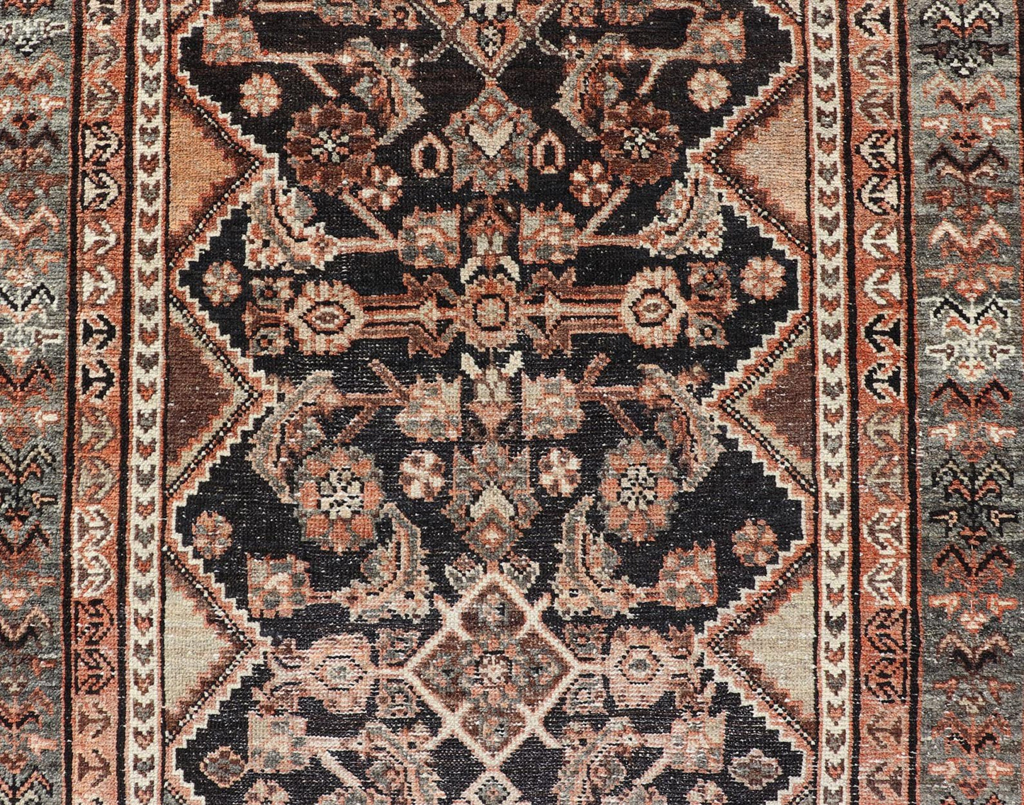 Measures: 3'6 x 6'4 The rug's central field features a dark background adorned with detailed floral and geometric motifs in shades of beige, brown, and soft orange. The design is symmetrical, with a central medallion and repeating patterns that cre... - Keivan Woven ArtsEMB - 22239 - 22478