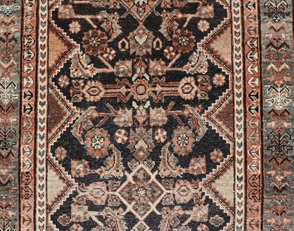 Measures: 3'6 x 6'4 The rug's central field features a dark background adorned with detailed floral and geometric motifs in shades of beige, brown, and soft orange. The design is symmetrical, with a central medallion and repeating patterns that cre... - Keivan Woven ArtsEMB - 22239 - 22478