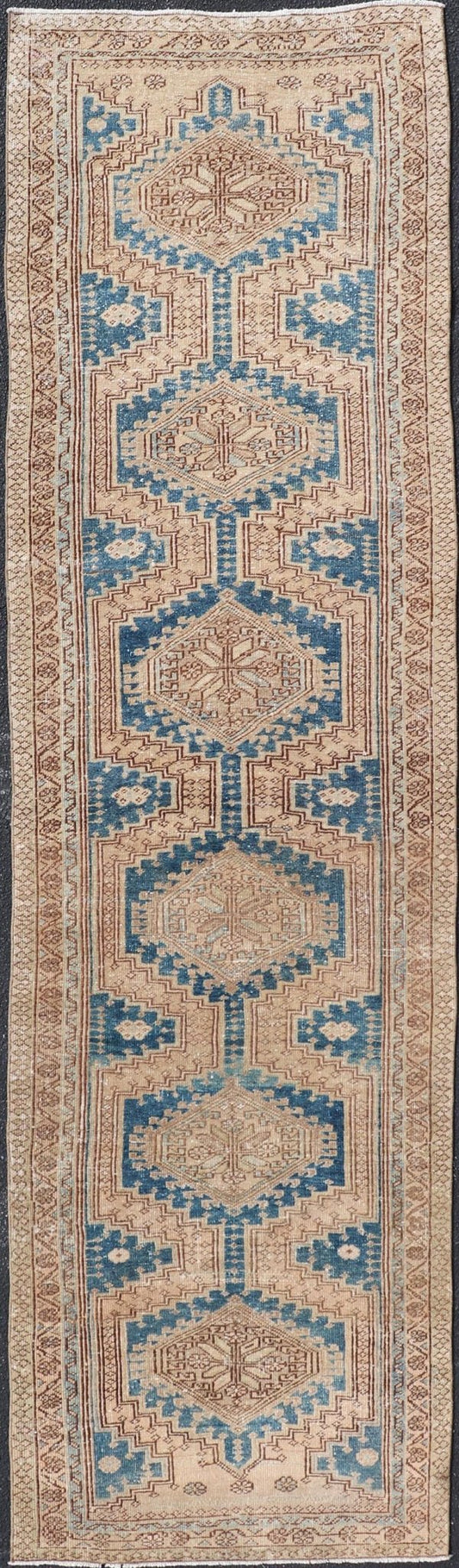 Measures: 3'0 x 10'10 This antique Persian Heriz runner with a distinctive and elegant design. The runner showcases a series of connected geometric medallions running along its length, each intricately detailed with traditional motifs. The central ... - Keivan Woven ArtsEMB - 22240 - 22484Rug