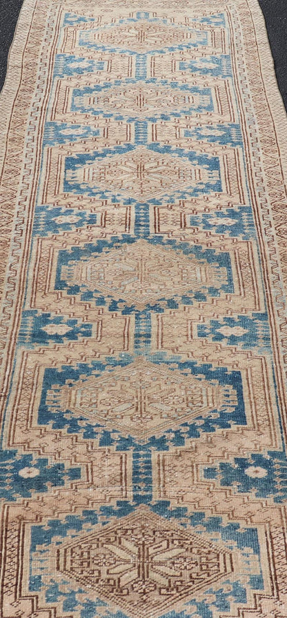 Measures: 3'0 x 10'10 This antique Persian Heriz runner with a distinctive and elegant design. The runner showcases a series of connected geometric medallions running along its length, each intricately detailed with traditional motifs. The central ... - Keivan Woven ArtsEMB - 22240 - 22484
