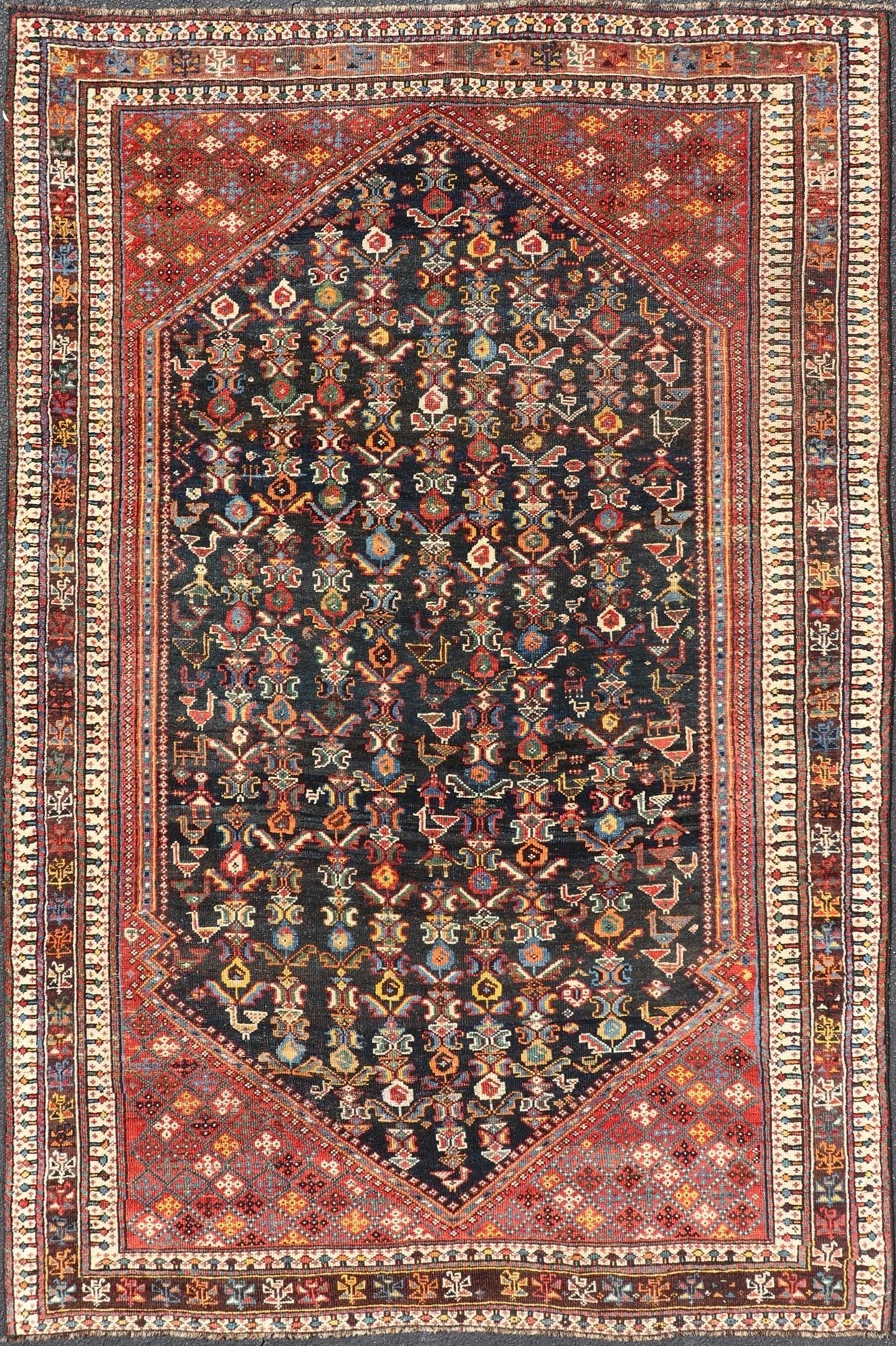 Measures: 5'7 x 8'10 This Qashgai rug has rich heritage and intricate design characteristic of this nomadic tribe from southwestern Iran. The rug features a dense, dark blue field adorned with a myriad of vibrant, detailed motifs, including ani... - Keivan Woven ArtsEMB - 22245 - 22508