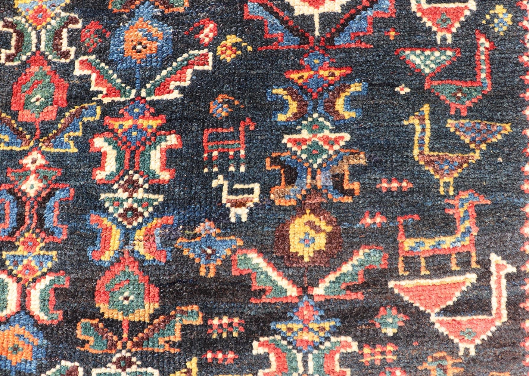 Measures: 5'7 x 8'10 This Qashgai rug has rich heritage and intricate design characteristic of this nomadic tribe from southwestern Iran. The rug features a dense, dark blue field adorned with a myriad of vibrant, detailed motifs, including ani... - Keivan Woven ArtsEMB - 22245 - 22508