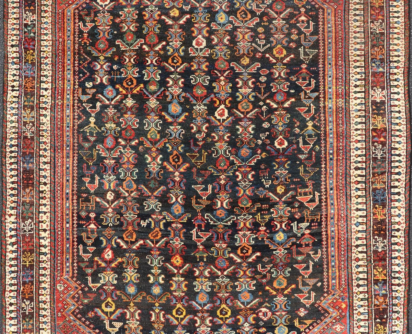 Measures: 5'7 x 8'10 This Qashgai rug has rich heritage and intricate design characteristic of this nomadic tribe from southwestern Iran. The rug features a dense, dark blue field adorned with a myriad of vibrant, detailed motifs, including ani... - Keivan Woven ArtsEMB - 22245 - 22508