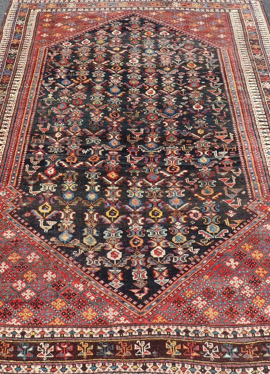 Measures: 5'7 x 8'10 This Qashgai rug has rich heritage and intricate design characteristic of this nomadic tribe from southwestern Iran. The rug features a dense, dark blue field adorned with a myriad of vibrant, detailed motifs, including ani... - Keivan Woven ArtsEMB - 22245 - 22508