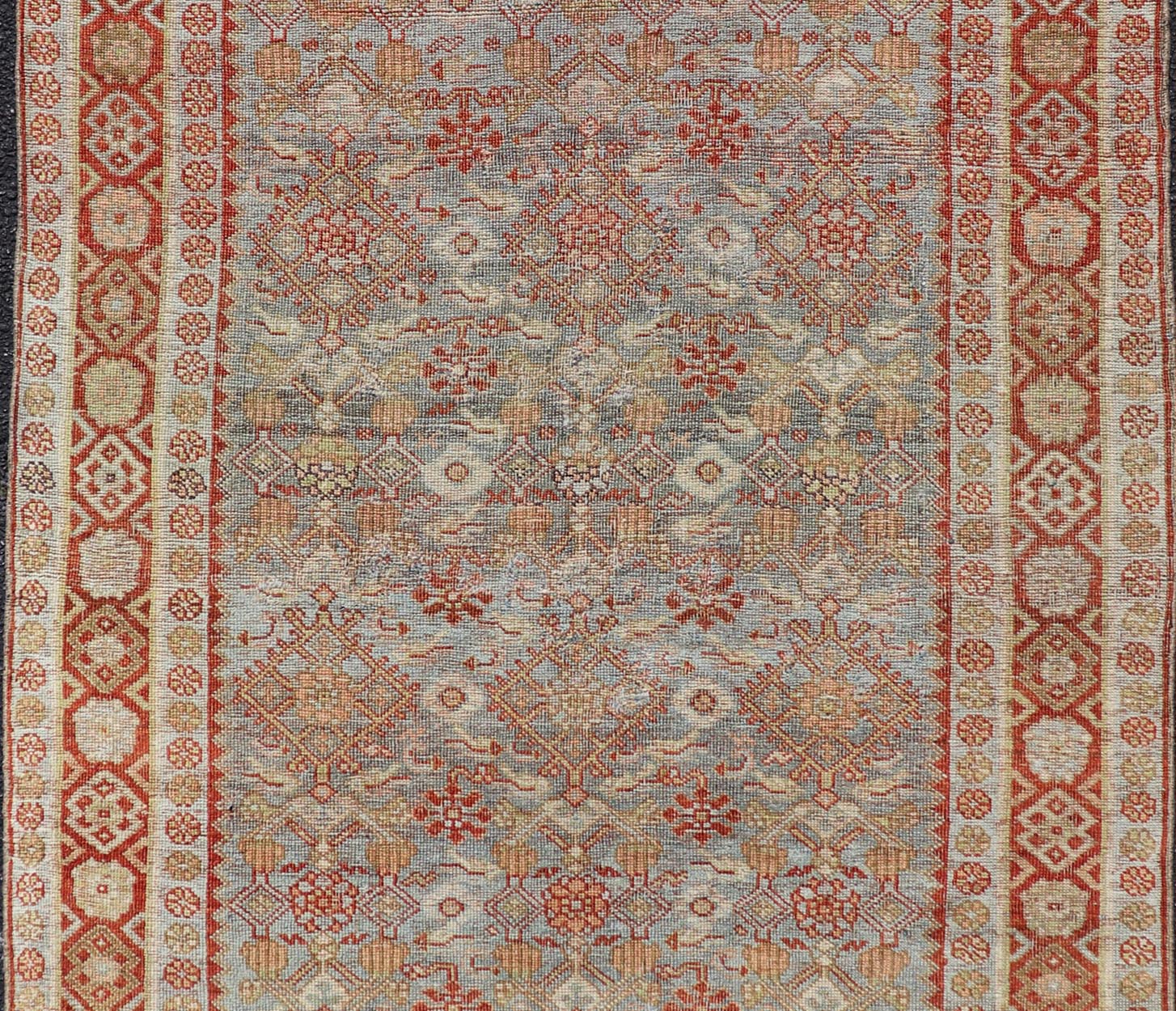 Measures: 4'3 x 7'5 This exquisite Antique Bidjar rug exemplifies the grandeur and meticulous craftsmanship synonymous with one of the most durable Persian carpets. The rug features a harmonious blend of sky blue and rusty red hues, providing a stu... - Keivan Woven ArtsEMB - 22246 - 22514Rug