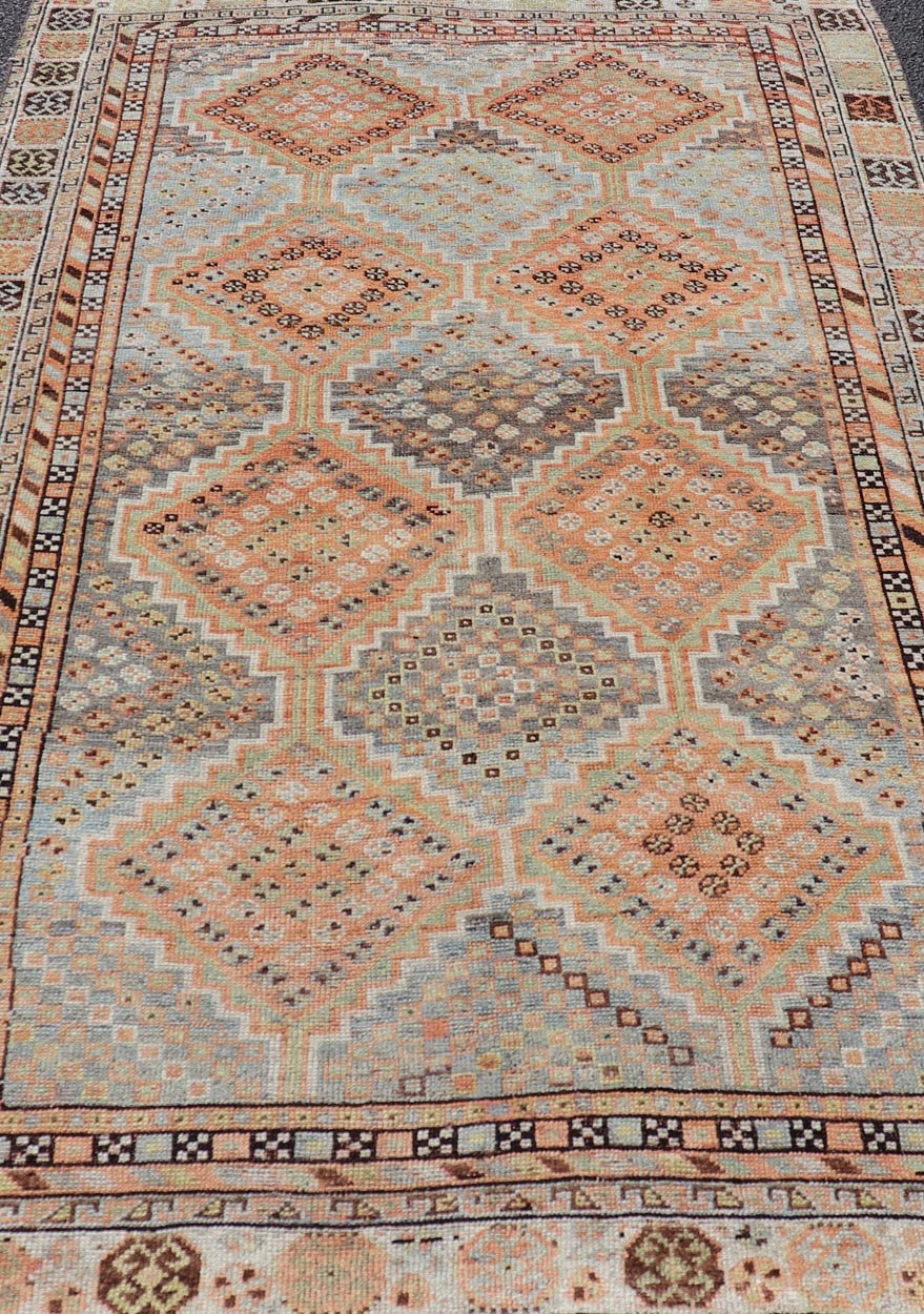 Measures: 4'7 x 8'0 This exquisite antique Shiraz rug features a striking geometric diamond motif, characteristic of the rich weaving tradition of the Shiraz region in southwestern Iran. The central field is adorned with a series of interconnected ... - Keivan Woven ArtsEMB - 22249 - 22520