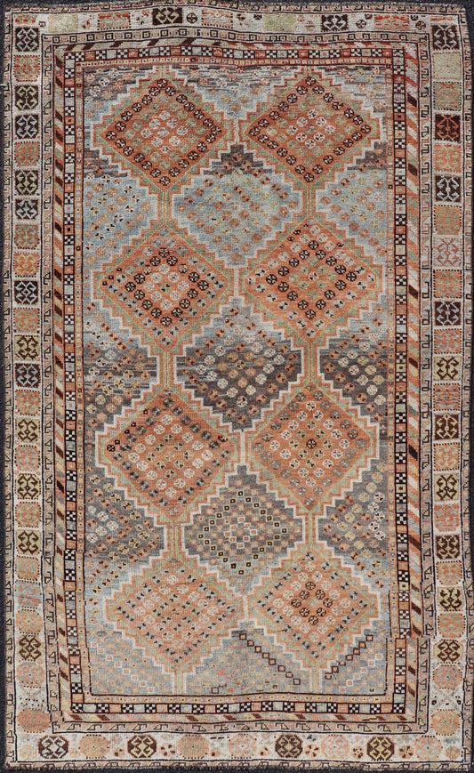 Measures: 4'7 x 8'0 This exquisite antique Shiraz rug features a striking geometric diamond motif, characteristic of the rich weaving tradition of the Shiraz region in southwestern Iran. The central field is adorned with a series of interconnected ... - Keivan Woven ArtsEMB - 22249 - 22520