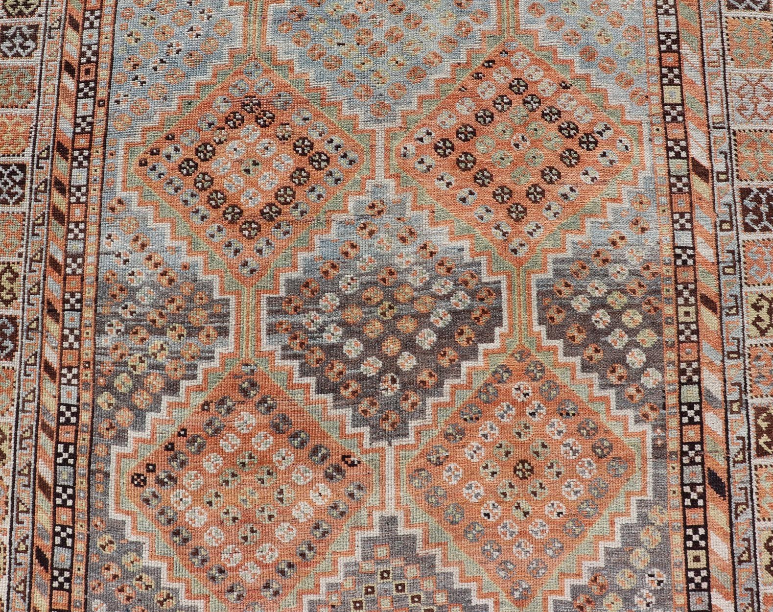 Measures: 4'7 x 8'0 This exquisite antique Shiraz rug features a striking geometric diamond motif, characteristic of the rich weaving tradition of the Shiraz region in southwestern Iran. The central field is adorned with a series of interconnected ... - Keivan Woven ArtsEMB - 22249 - 22520