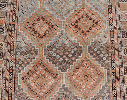Measures: 4'7 x 8'0 This exquisite antique Shiraz rug features a striking geometric diamond motif, characteristic of the rich weaving tradition of the Shiraz region in southwestern Iran. The central field is adorned with a series of interconnected ... - Keivan Woven ArtsEMB - 22249 - 22520
