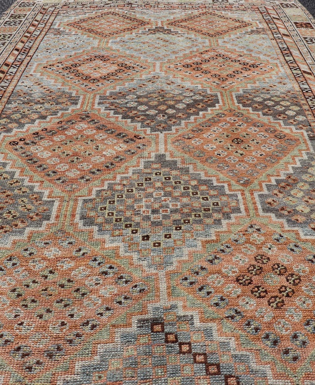 Measures: 4'7 x 8'0 This exquisite antique Shiraz rug features a striking geometric diamond motif, characteristic of the rich weaving tradition of the Shiraz region in southwestern Iran. The central field is adorned with a series of interconnected ... - Keivan Woven ArtsEMB - 22249 - 22520