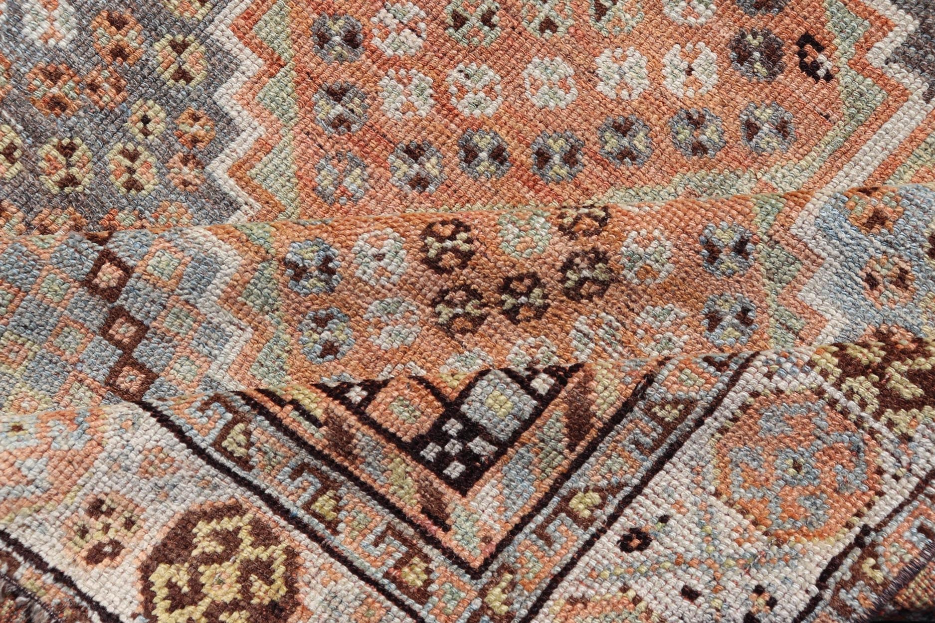 Measures: 4'7 x 8'0 This exquisite antique Shiraz rug features a striking geometric diamond motif, characteristic of the rich weaving tradition of the Shiraz region in southwestern Iran. The central field is adorned with a series of interconnected ... - Keivan Woven ArtsEMB - 22249 - 22520