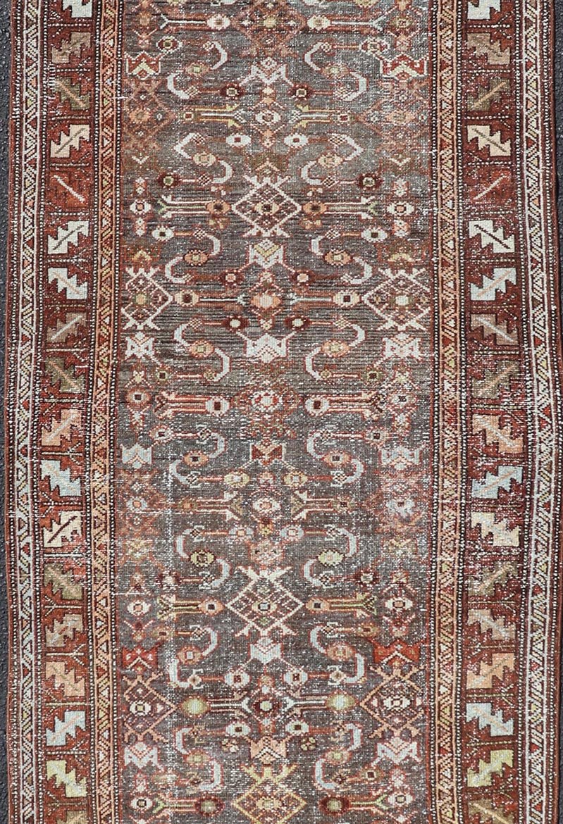 Measures: 3'1 x 9'10 This distinguished antique runner rug hails from the Northwest region of Persia, crafted in the early 20th century. The rug features a captivating central field adorned with intricate geometric and floral motifs in a palette of... - Keivan Woven ArtsEMB - 22257 - 22562