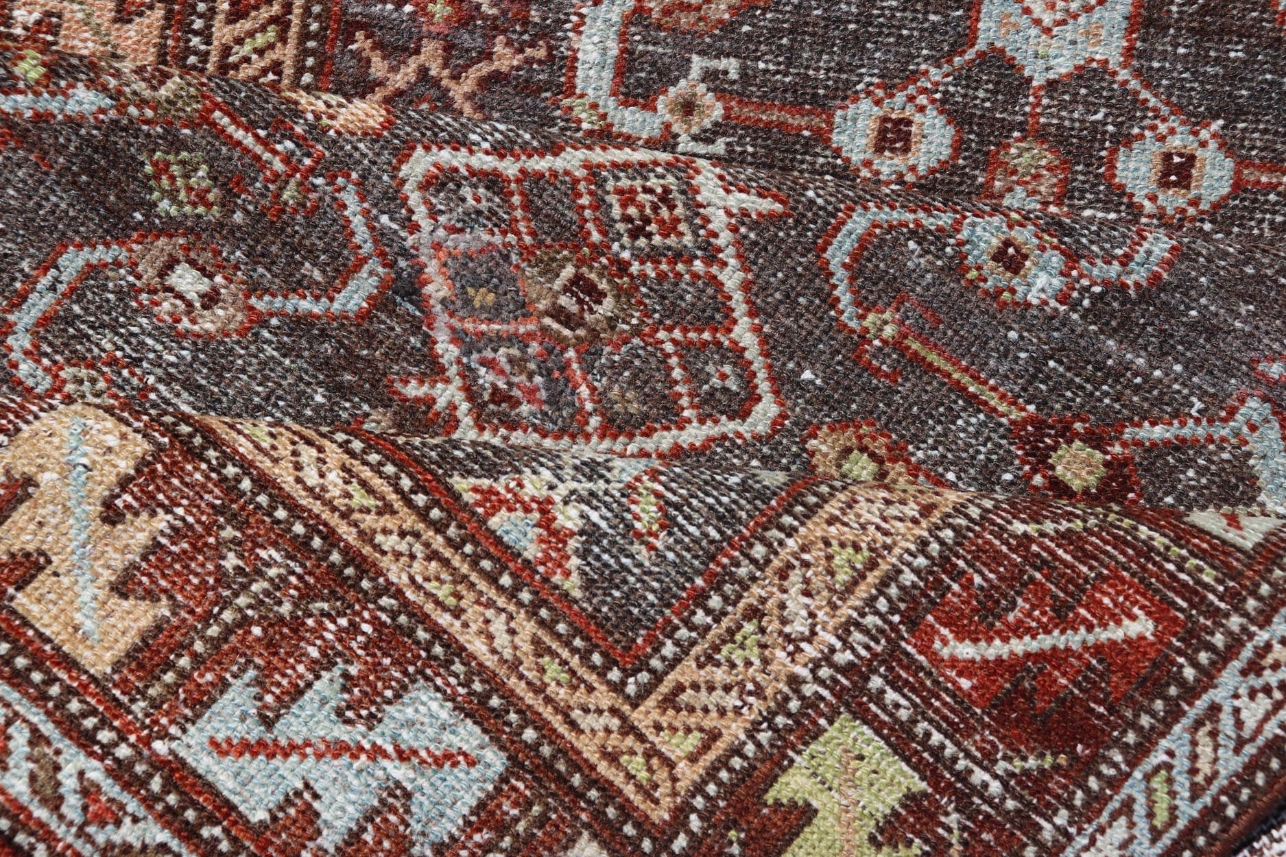 Measures: 3'1 x 9'10 This distinguished antique runner rug hails from the Northwest region of Persia, crafted in the early 20th century. The rug features a captivating central field adorned with intricate geometric and floral motifs in a palette of... - Keivan Woven ArtsEMB - 22257 - 22562
