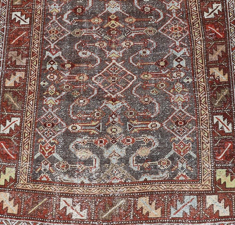 Measures: 3'1 x 9'10 This distinguished antique runner rug hails from the Northwest region of Persia, crafted in the early 20th century. The rug features a captivating central field adorned with intricate geometric and floral motifs in a palette of... - Keivan Woven ArtsEMB - 22257 - 22562