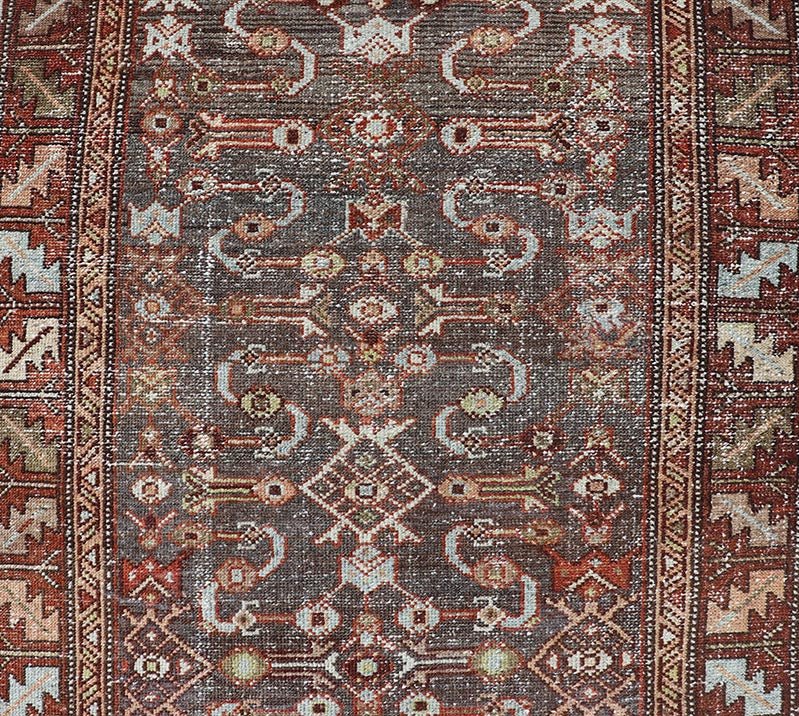 Measures: 3'1 x 9'10 This distinguished antique runner rug hails from the Northwest region of Persia, crafted in the early 20th century. The rug features a captivating central field adorned with intricate geometric and floral motifs in a palette of... - Keivan Woven ArtsEMB - 22257 - 22562