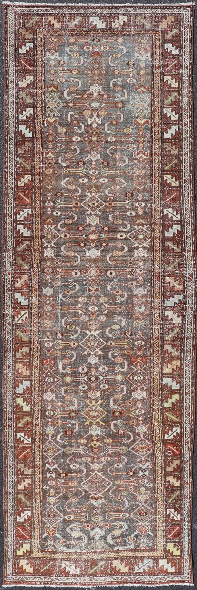 Measures: 3'1 x 9'10 This distinguished antique runner rug hails from the Northwest region of Persia, crafted in the early 20th century. The rug features a captivating central field adorned with intricate geometric and floral motifs in a palette of... - Keivan Woven ArtsEMB - 22257 - 22562