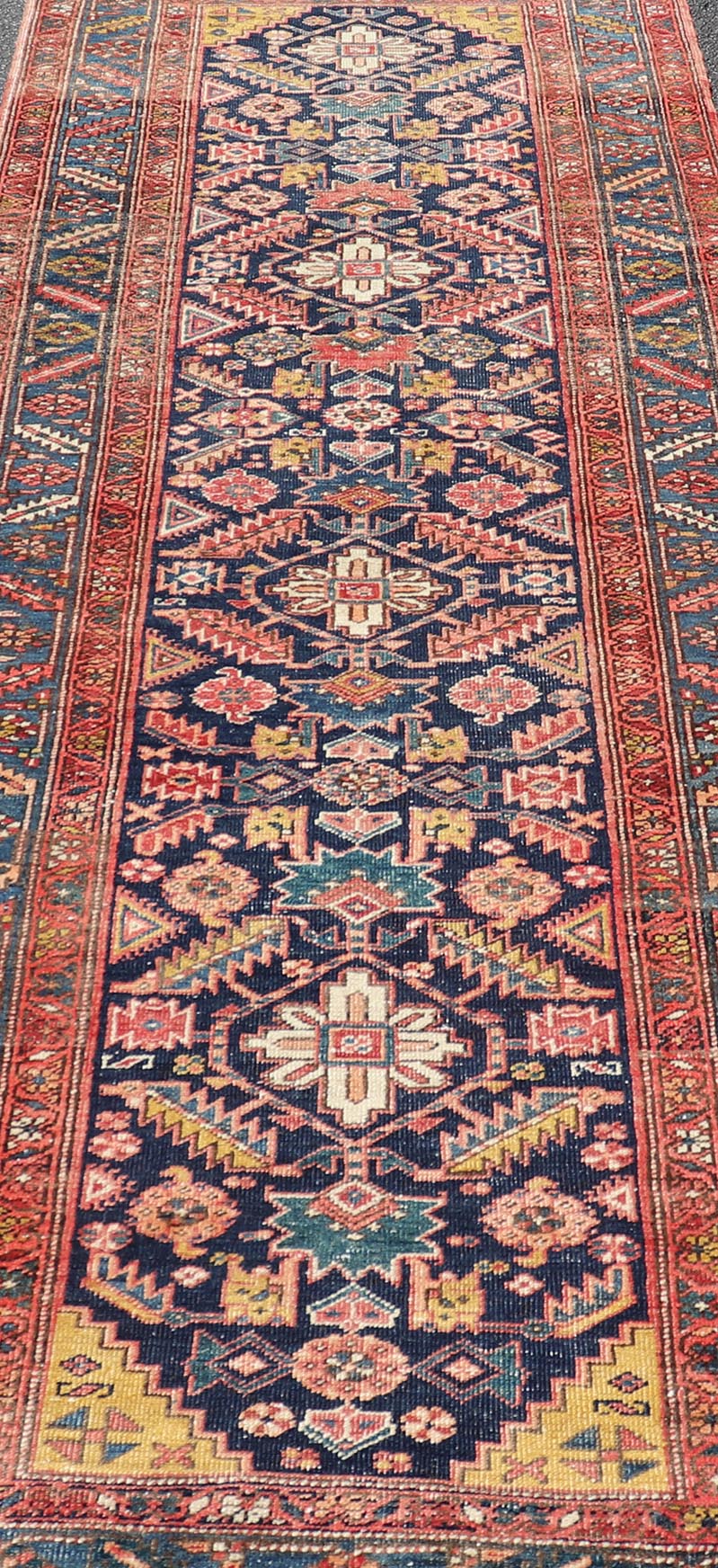 Measures: 3'9 x 11'3 This stunning Serapi runner, an exceptional example of Persian weaving, displays a vibrant and intricate design characteristic of the Serapi style known for its sophistication and complexity. The rug features a rich, dark blue ... - Keivan Woven ArtsEMB - 22258 - 22568
