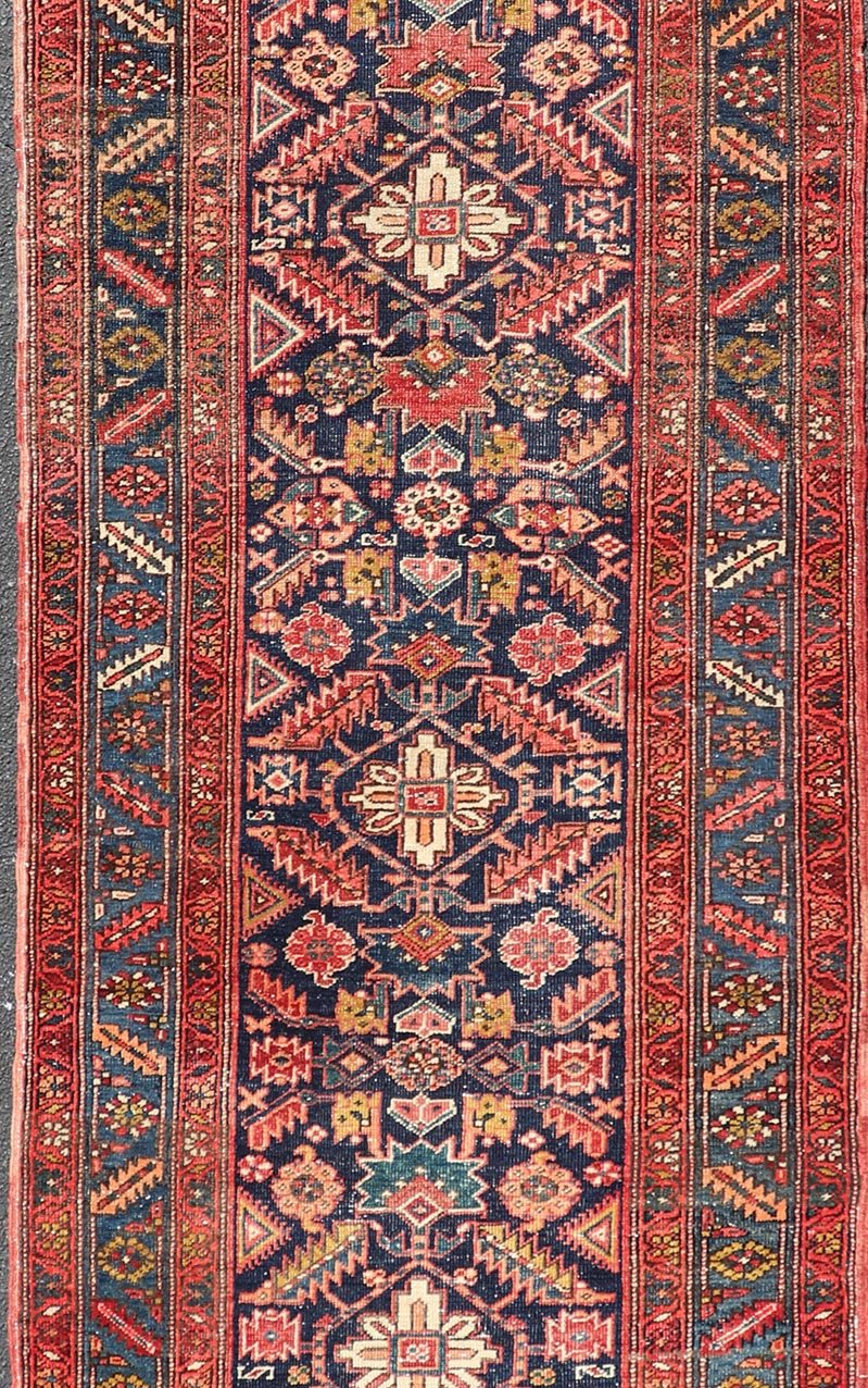 Measures: 3'9 x 11'3 This stunning Serapi runner, an exceptional example of Persian weaving, displays a vibrant and intricate design characteristic of the Serapi style known for its sophistication and complexity. The rug features a rich, dark blue ... - Keivan Woven ArtsEMB - 22258 - 22568