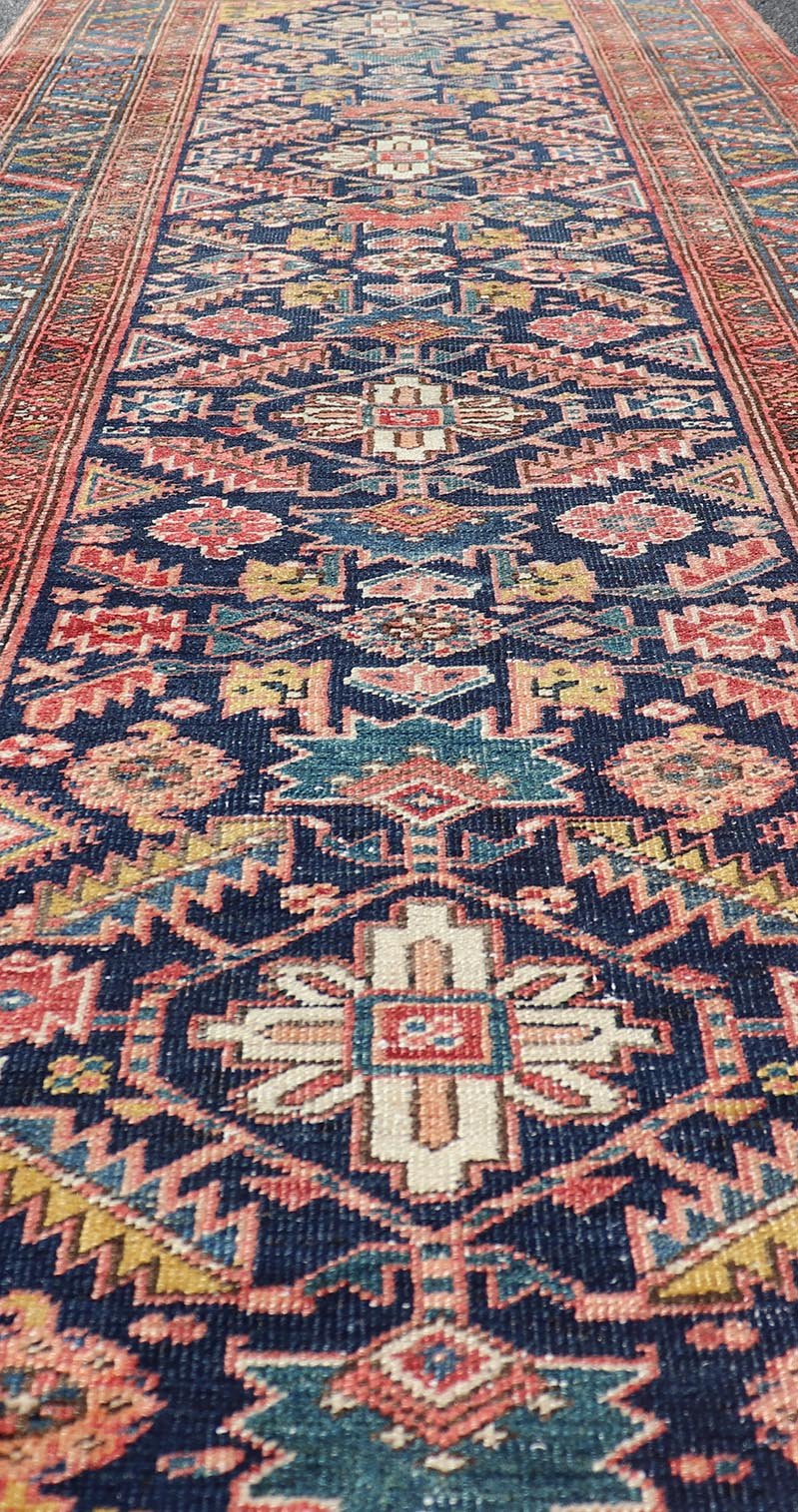 Measures: 3'9 x 11'3 This stunning Serapi runner, an exceptional example of Persian weaving, displays a vibrant and intricate design characteristic of the Serapi style known for its sophistication and complexity. The rug features a rich, dark blue ... - Keivan Woven ArtsEMB - 22258 - 22568