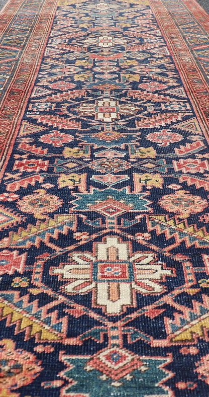 Measures: 3'9 x 11'3 This stunning Serapi runner, an exceptional example of Persian weaving, displays a vibrant and intricate design characteristic of the Serapi style known for its sophistication and complexity. The rug features a rich, dark blue ... - Keivan Woven ArtsEMB - 22258 - 22568