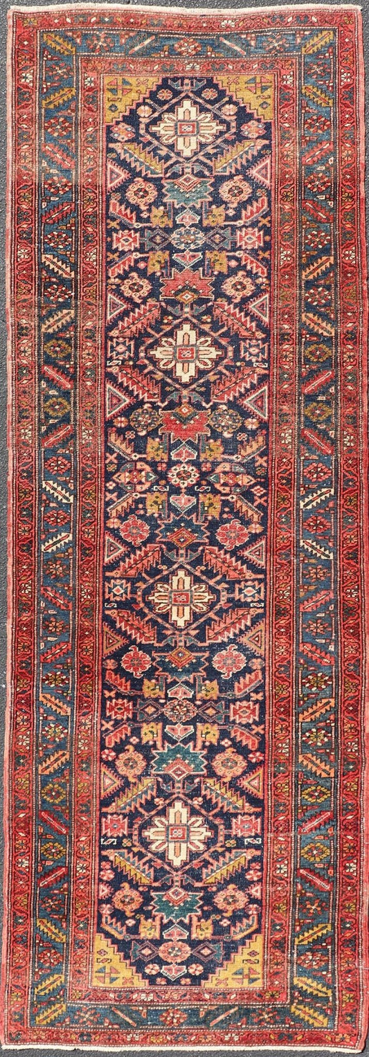 Measures: 3'9 x 11'3 This stunning Serapi runner, an exceptional example of Persian weaving, displays a vibrant and intricate design characteristic of the Serapi style known for its sophistication and complexity. The rug features a rich, dark blue ... - Keivan Woven ArtsEMB - 22258 - 22568Rug