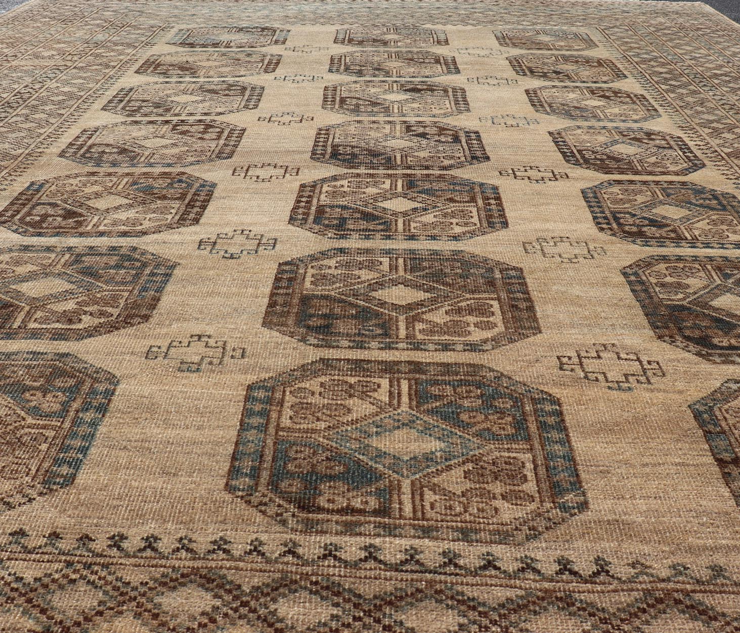 Measures: 8'7 x 11'10 This antique Ersari rug captures the essence of traditional tribal artistry, characterized by its structured array of medallions and rich, earthy tones. The rug features a series of octagonal medallions aligned in a formal, or... - Keivan Woven ArtsEMB - 22279 - 26100Rug