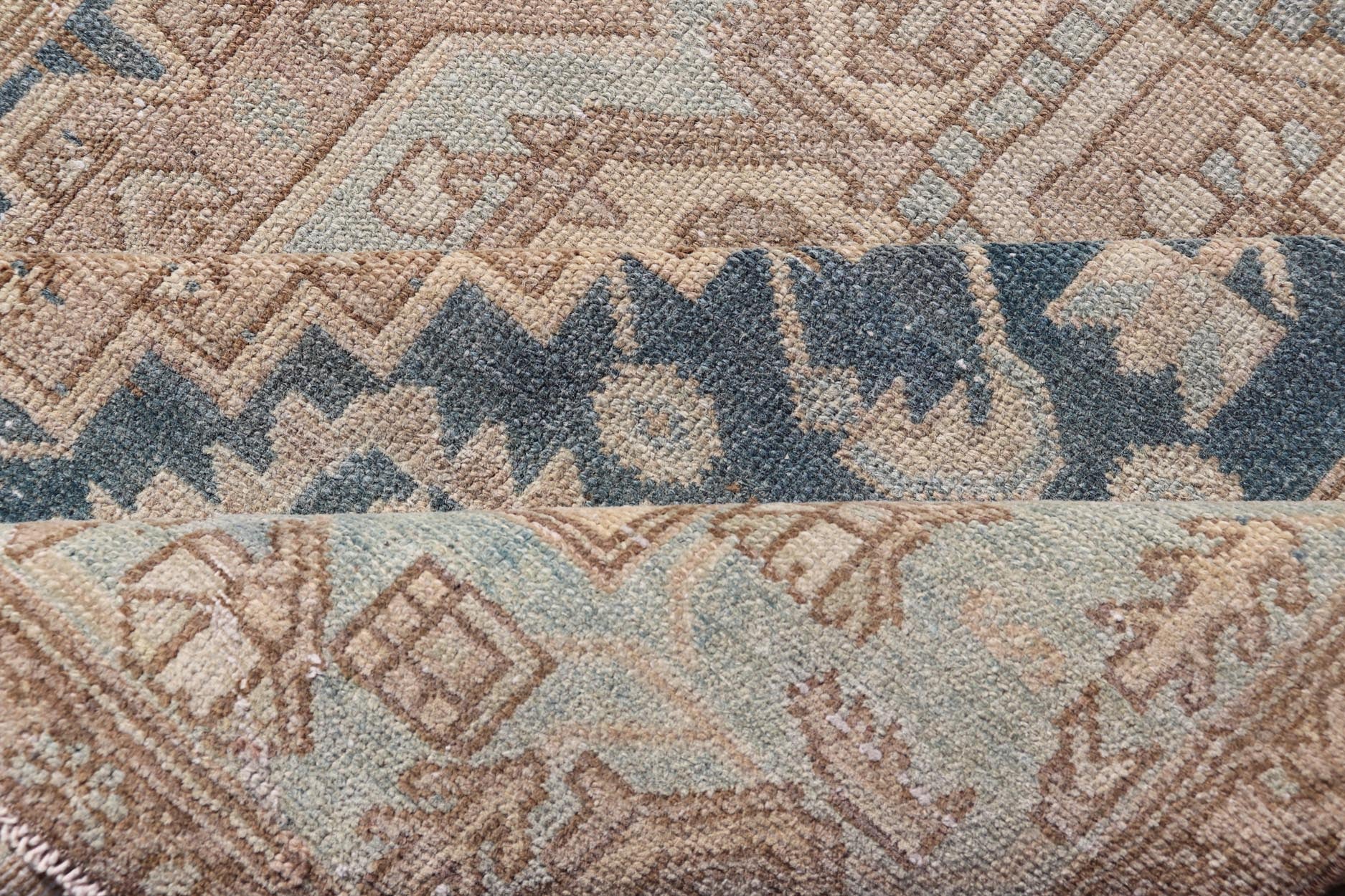 Measures: 4'2 x 6'4 This antique Persian Hamadan rug exemplifies traditional craftsmanship with its bold geometric designs and a harmonious color palette. The rug features a stunning central medallion, highlighted by its intricate detailing and sha... - Keivan Woven ArtsEMB - 22280 - 26190
