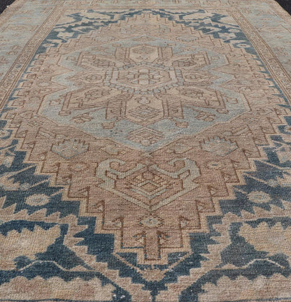 Measures: 4'2 x 6'4 This antique Persian Hamadan rug exemplifies traditional craftsmanship with its bold geometric designs and a harmonious color palette. The rug features a stunning central medallion, highlighted by its intricate detailing and sha... - Keivan Woven ArtsEMB - 22280 - 26190