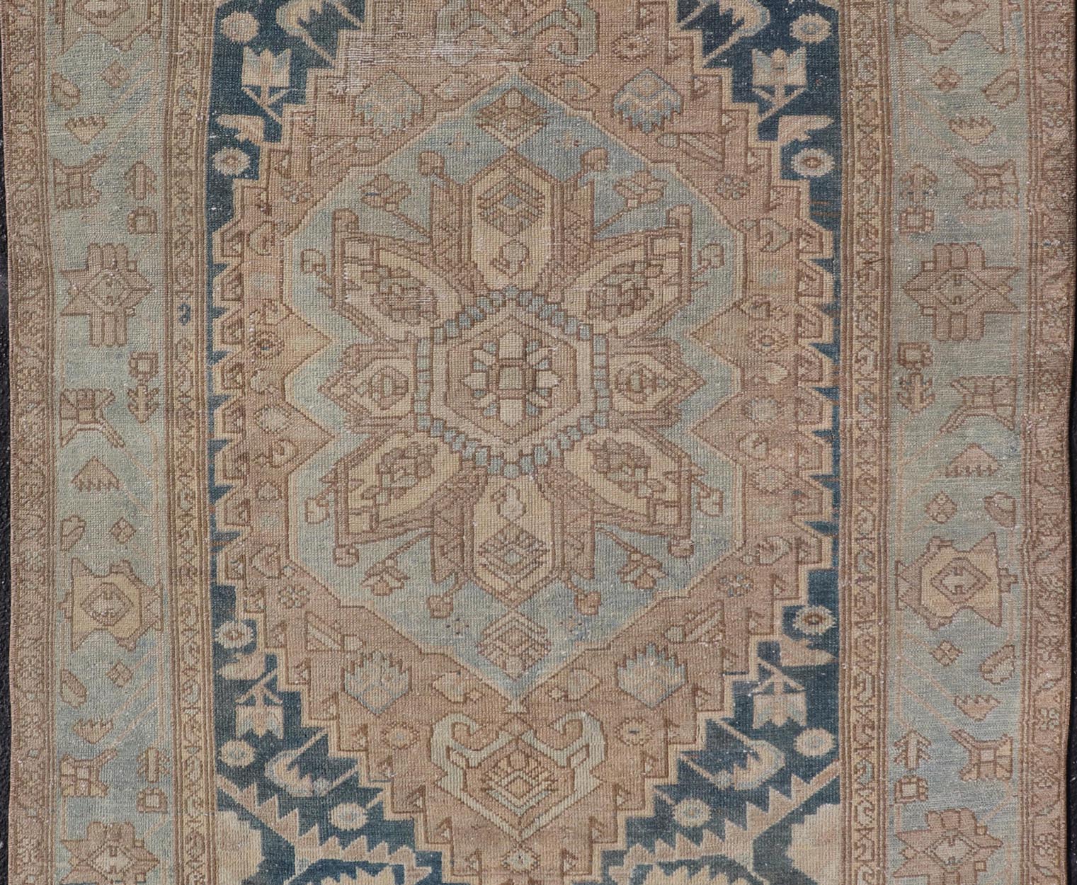 Measures: 4'2 x 6'4 This antique Persian Hamadan rug exemplifies traditional craftsmanship with its bold geometric designs and a harmonious color palette. The rug features a stunning central medallion, highlighted by its intricate detailing and sha... - Keivan Woven ArtsEMB - 22280 - 26190