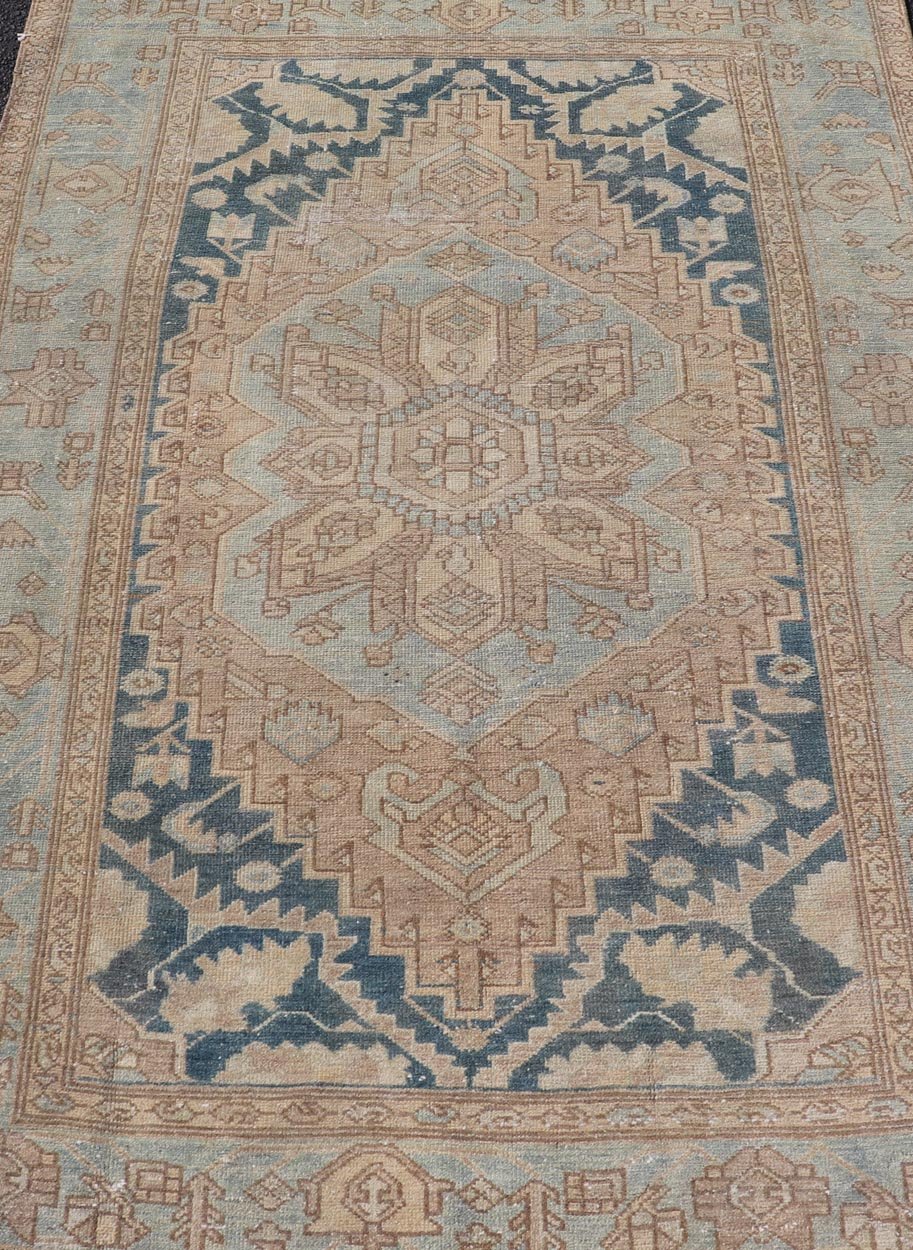 Measures: 4'2 x 6'4 This antique Persian Hamadan rug exemplifies traditional craftsmanship with its bold geometric designs and a harmonious color palette. The rug features a stunning central medallion, highlighted by its intricate detailing and sha... - Keivan Woven ArtsEMB - 22280 - 26190