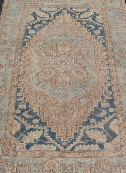 Measures: 4'2 x 6'4 This antique Persian Hamadan rug exemplifies traditional craftsmanship with its bold geometric designs and a harmonious color palette. The rug features a stunning central medallion, highlighted by its intricate detailing and sha... - Keivan Woven ArtsEMB - 22280 - 26190