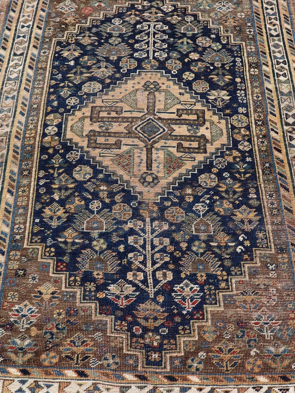Measures: 3'6 x 5'4 This magnificent antique Persian Shiraz rug is a stunning example of traditional tribal craftsmanship. The rug is dominated by a deep navy field that beautifully contrasts with the rich array of tribal motifs and symbols in vibr... - Keivan Woven ArtsEMB - 22282 - 26106Rug