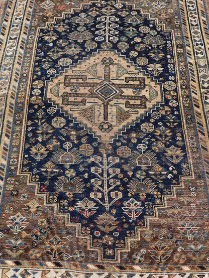 Measures: 3'6 x 5'4 This magnificent antique Persian Shiraz rug is a stunning example of traditional tribal craftsmanship. The rug is dominated by a deep navy field that beautifully contrasts with the rich array of tribal motifs and symbols in vibr... - Keivan Woven ArtsEMB - 22282 - 26106Rug