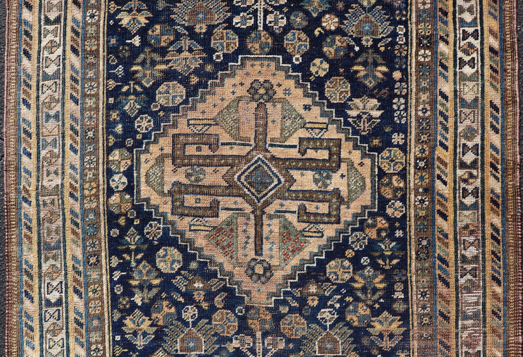 Measures: 3'6 x 5'4 This magnificent antique Persian Shiraz rug is a stunning example of traditional tribal craftsmanship. The rug is dominated by a deep navy field that beautifully contrasts with the rich array of tribal motifs and symbols in vibr... - Keivan Woven ArtsEMB - 22282 - 26106Rug