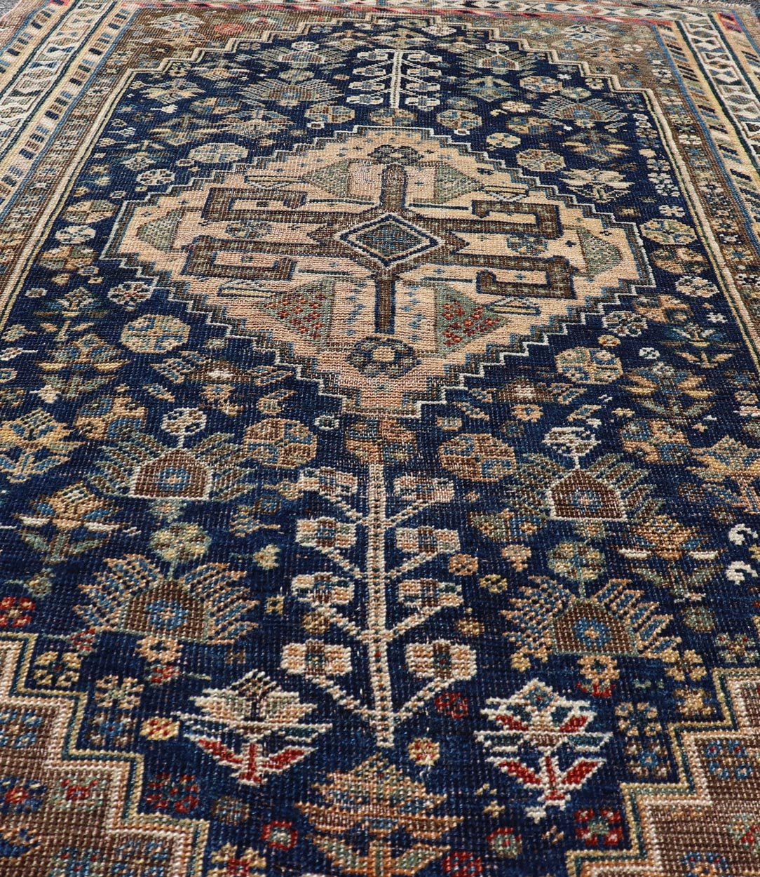 Measures: 3'6 x 5'4 This magnificent antique Persian Shiraz rug is a stunning example of traditional tribal craftsmanship. The rug is dominated by a deep navy field that beautifully contrasts with the rich array of tribal motifs and symbols in vibr... - Keivan Woven ArtsEMB - 22282 - 26106Rug