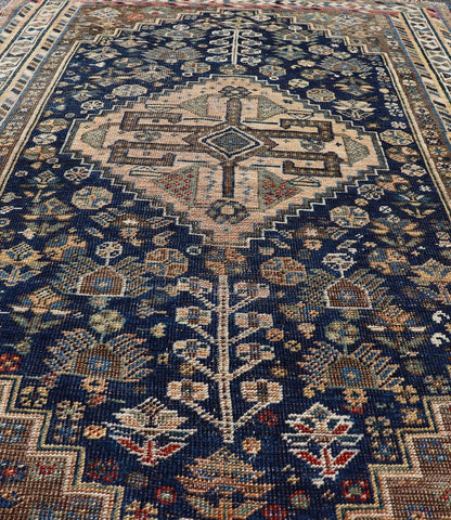 Measures: 3'6 x 5'4 This magnificent antique Persian Shiraz rug is a stunning example of traditional tribal craftsmanship. The rug is dominated by a deep navy field that beautifully contrasts with the rich array of tribal motifs and symbols in vibr... - Keivan Woven ArtsEMB - 22282 - 26106Rug