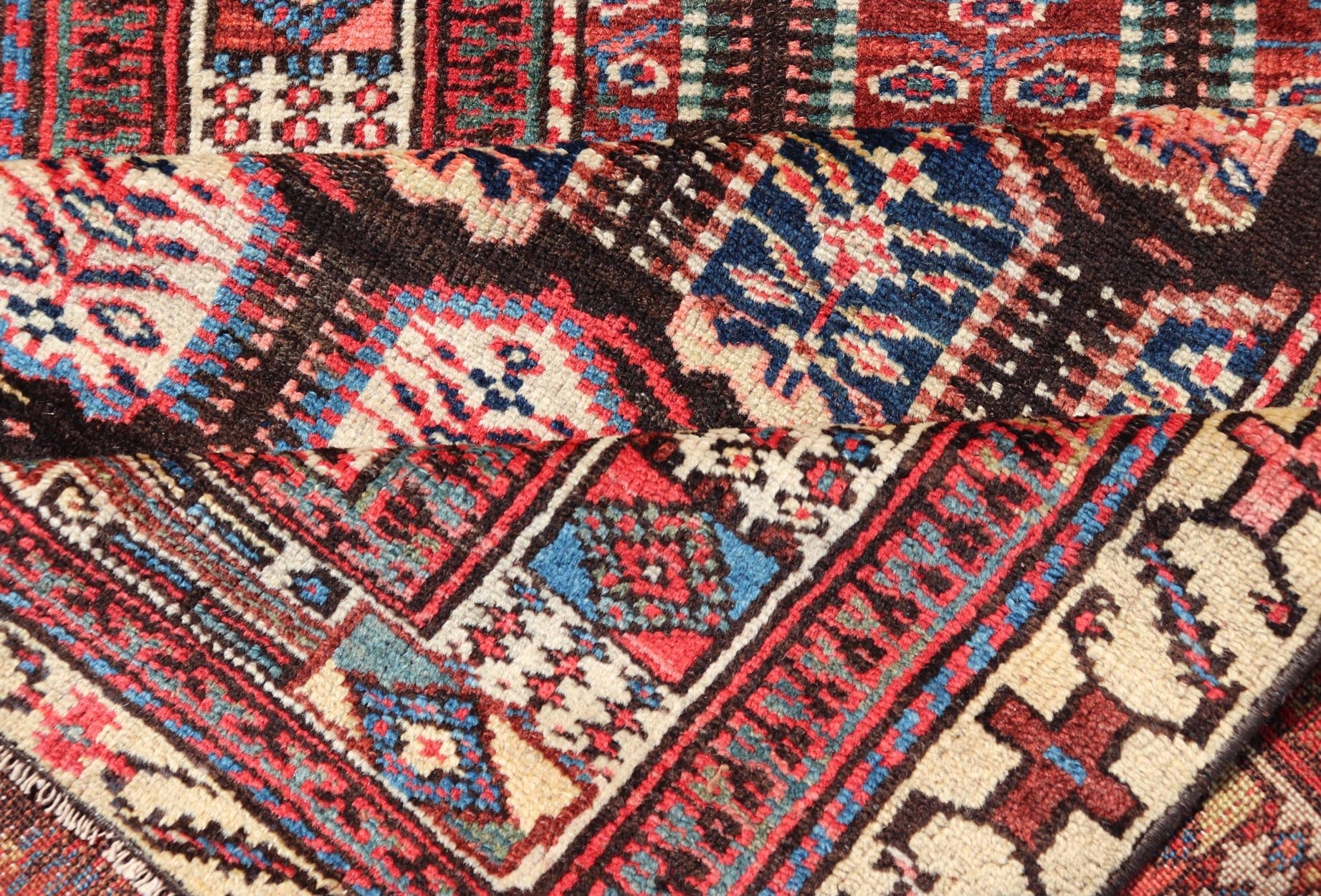 Measures: 3'3 x 8'4 This stunning antique Persian Kurdish runner showcases a vibrant and intricate design, reflecting the rich tribal heritage of Kurdish craftsmanship. The rug features a series of repeated medallions, each intricately detailed wit... - Keivan Woven ArtsEMB - 22288 - 26124Rug